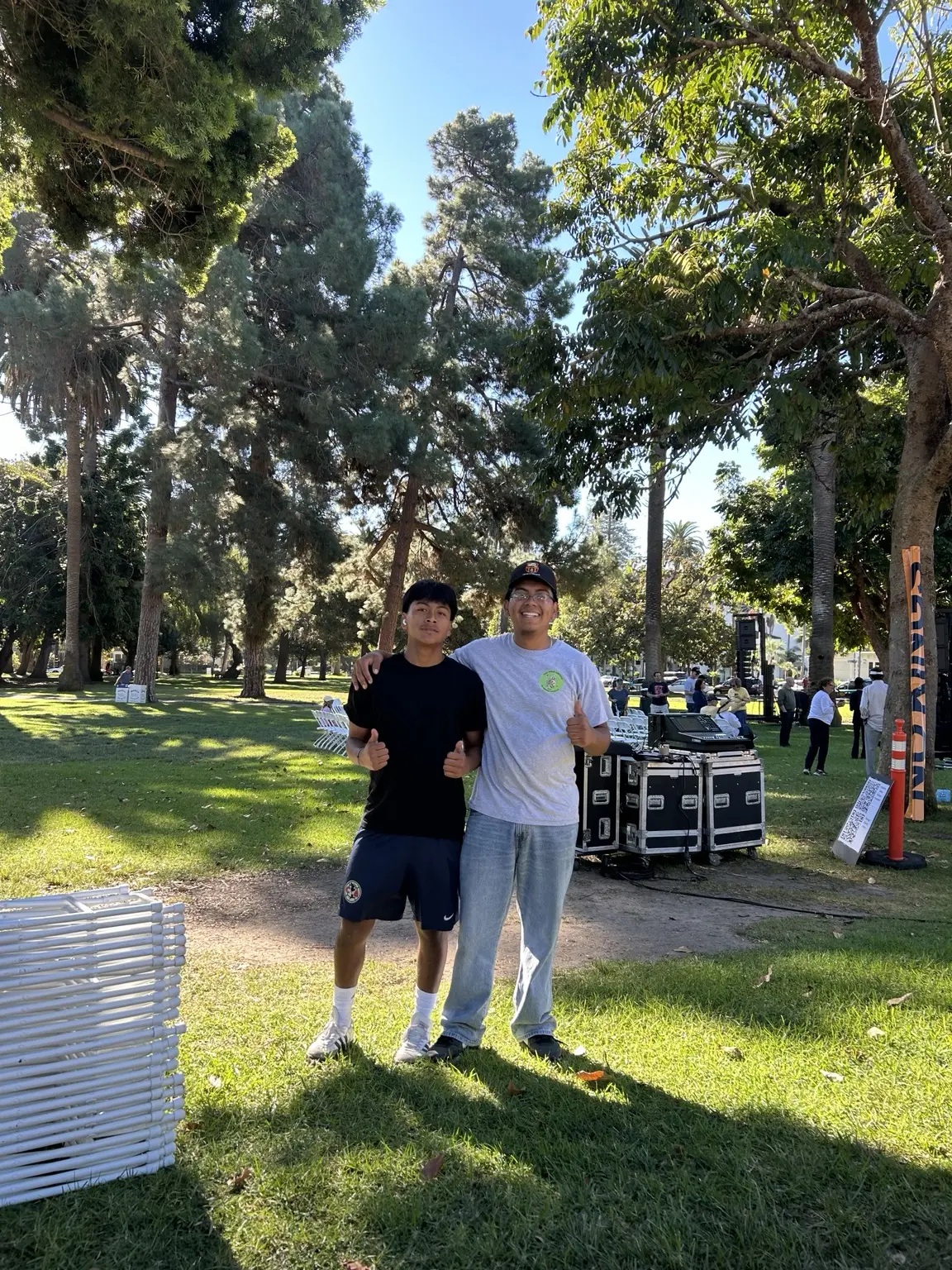The young owner of San Judas Party Rentals with a team member at an outdoor event