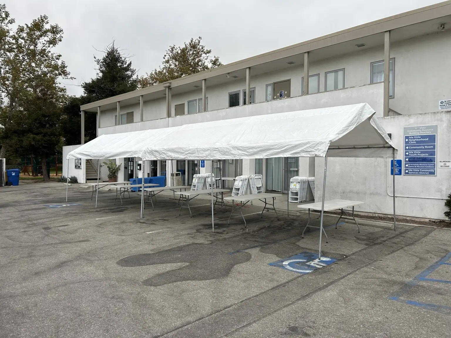 Large white party tent with folding tables and chairs